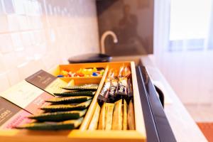 a box filled with chopsticks and vegetables on a counter at Apartament ALESSIO in Drobeta-Turnu Severin