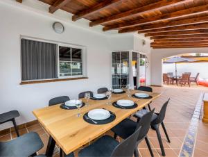 a dining room with a wooden table and chairs at PRIMERA LUXURY HOUSE in Caleta De Fuste