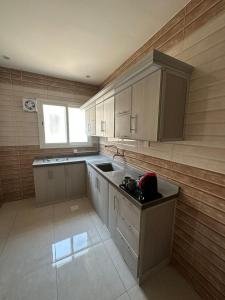 a kitchen with a sink and a counter top at Sunrise Suites in Tabuk