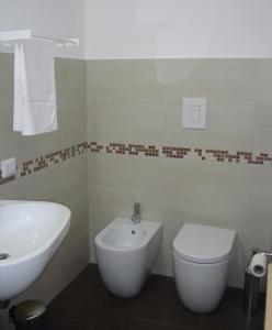 a bathroom with a white sink and a toilet at B&B Verziere in Iesi