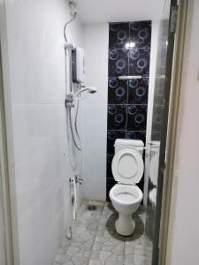 a bathroom with a toilet and a phone on the wall at The Big Family Homestay in Alor Setar