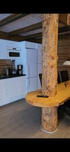 a wooden table in a room with a kitchen at Ammeråns Fiskecamp in Hammarstrand