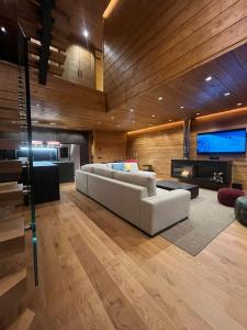 a living room with a white couch and a fireplace at Lux 12 in Sierra Nevada