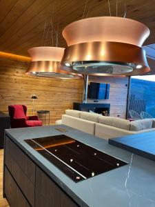 a living room with a couch and a kitchen with lights at Lux 12 in Sierra Nevada