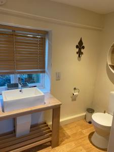 a bathroom with a sink and a toilet at Little Barn in Dorchester +13 photos