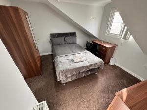 a small bedroom with a bed and a desk at Seven Stars of Heeley Selly Oak in Birmingham