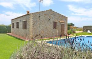 a stone house with a pool in front of it at Chalet Piedra in Conil de la Frontera