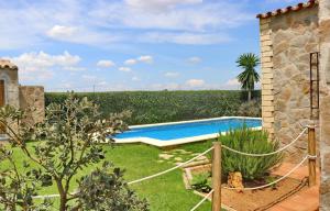 a backyard with a swimming pool and a garden at Chalet Piedra in Conil de la Frontera