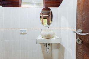 a bathroom with a sink and a mirror at RedDoorz Resort @ Taman Wisata Mangrove in Jakarta
