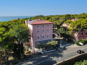 an aerial view of a pink building on a street at Castiglioncello Suite in Castiglioncello