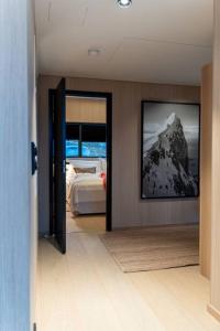 - une chambre avec un lit et une photo de montagne dans l'établissement Luksushytte med Jacuzzi, Summer&Winter Retreat, à Lyngværet