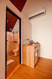 a bathroom with a sink and a toilet at Padi Villas by Aayan in Canggu