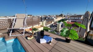 - un balcon avec une chaise et une piscine dans un bâtiment dans l'établissement RentalSevilla Cardenal Cervantes, à Séville