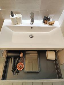 a white sink in a bathroom with a shelf underneath it at YR Apartments Milan - Bocconi - Fashion Apartment in Milan