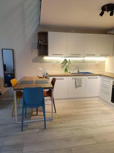 a kitchen with a table and chairs in a room at YR Apartments Milan - Bocconi - Fashion Apartment in Milan