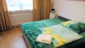a bedroom with a bed with a towel on it at Döhren - 2 Single rooms in Hannover