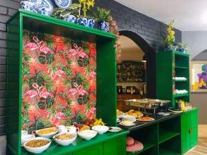 a display cabinet filled with plates and bowls of food at Grafiti Boutique Hotel in Bela-Bela