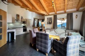 a living room with a couch and chairs and a table at Chalet Maiskogel Kaprun in Kaprun
