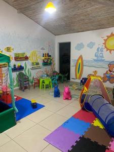 a childs room with a play room with a mural at Le Bon Vivant - Praia Grande - Arraial do Cabo in Arraial do Cabo