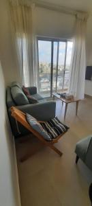 a living room with a couch and a large window at مبنى هلال in Amman