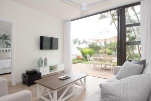 a living room with a couch and a table at 210 Breakers Resort Umhlanga Rocks in Durban