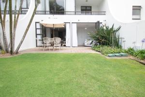 a patio with a lawn in front of a house at 210 Breakers Resort Umhlanga Rocks in Durban