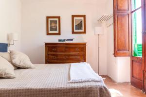 a bedroom with a wooden dresser and a bed at Villa La Fenice by Wonderful Italy in Castellammare del Golfo