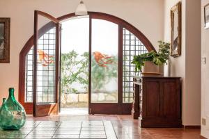 an open door with a glass vase in a room at Villa La Fenice by Wonderful Italy in Castellammare del Golfo
