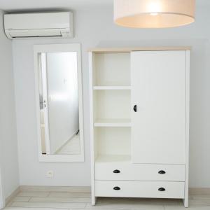 a dressing room with a mirror and a white dresser at Hotel La Ciotat - A deux pas de l'eau in La Ciotat