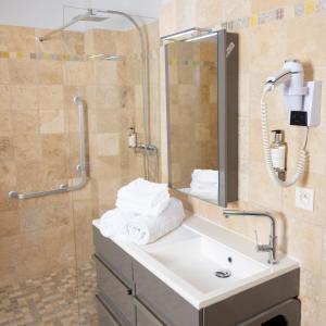 a bathroom with a sink and a shower at Hotel La Ciotat - A deux pas de l'eau in La Ciotat
