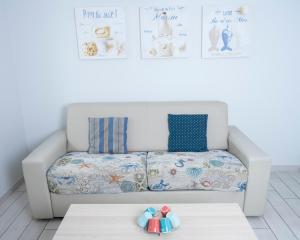 a white couch in a room with a table at Hotel La Ciotat - A deux pas de l'eau in La Ciotat