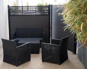 two chairs and a table on a patio at Hotel La Ciotat - A deux pas de l'eau in La Ciotat