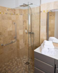 a bathroom with a shower and a sink at Hotel La Ciotat - A deux pas de l'eau in La Ciotat