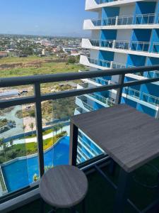 a balcony with a table and a view of a building at Azure North - Munar Suite in Lagundi