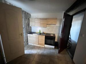 a small kitchen with a sink and a stove at Budget Inn th 23 - Downtown 3 Bedroom apartment in Szombathely