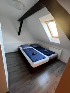 a bedroom with two beds in a attic at Budget Inn th 23 - Downtown 3 Bedroom apartment in Szombathely