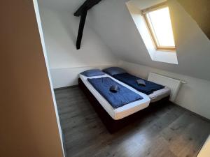 a small bed in a small room with a window at Budget Inn th 23 - Downtown 3 Bedroom apartment in Szombathely