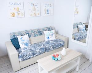 a living room with a couch and a table at Hotel La Ciotat - A deux pas de l'eau in La Ciotat