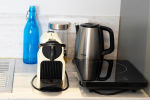 a coffeemaker and a coffee maker on a counter at Hotel La Ciotat - A deux pas de l'eau in La Ciotat
