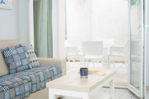 a living room with a couch and a coffee table at Hotel La Ciotat - A deux pas de l'eau in La Ciotat +23 photos
