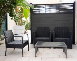 two chairs and a coffee table on a patio at Hotel La Ciotat - A deux pas de l'eau in La Ciotat