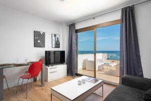 a living room with a view of the ocean at Antic 302 in S'Illot