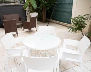 a white table and chairs on a patio at Hotel La Ciotat - A deux pas de l'eau in La Ciotat