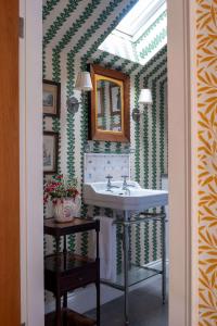 a bathroom with a sink and a mirror at Bert's - your idyllic Derbyshire retreat in Bonsall