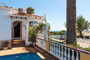 a villa with a swimming pool in front of a house at Villa Bienvenidos in Son Bou