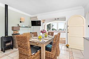 a dining room with a table and chairs and a fireplace at Villa Bienvenidos in Son Bou