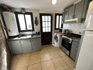 een keuken met een koelkast en een fornuis top oven bij Furnished apartment excellent location in La Cieneguita