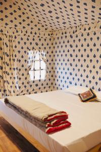 a bedroom with a bed with a patterned wall at K's Villa Bella in Bhuj