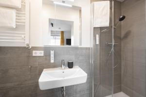 Ein Badezimmer in der Unterkunft Homaris Apartments München Laim
