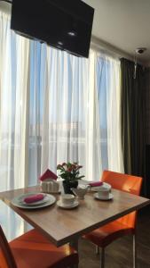 a dining room table with chairs and a table at Отель Бестау in Aksay